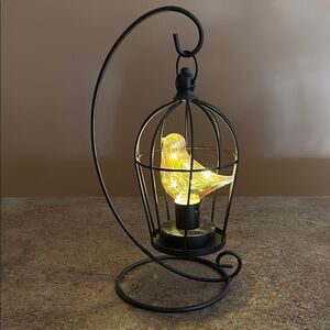 Birdcage battery operated on a stand.